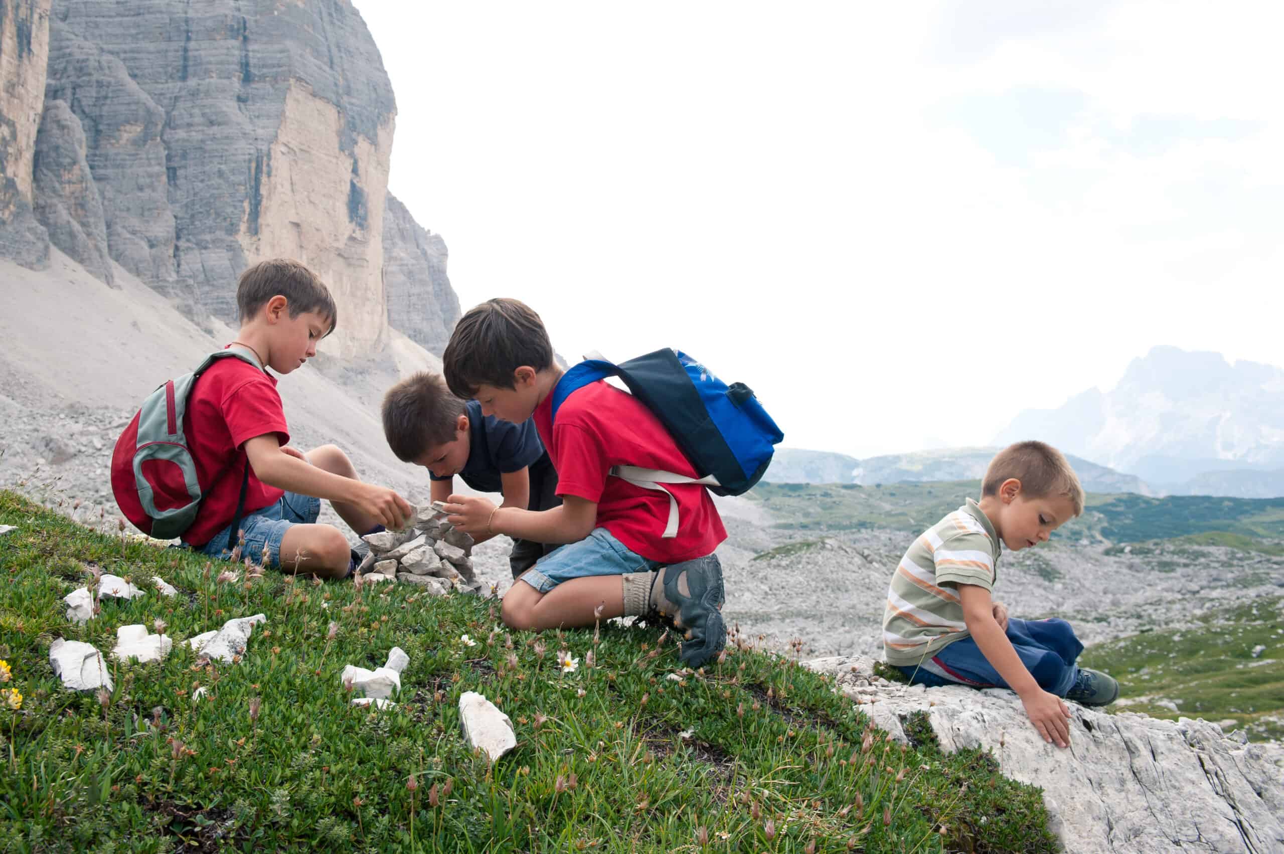 Kids playing in the mountains. Dolomites, Italy.