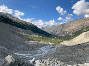 valley with a stream in the middle